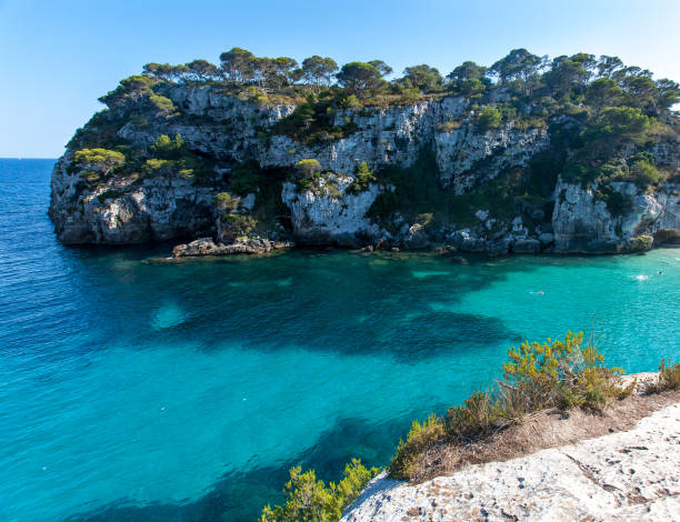 istock Cala Macarella and Cala Macarelleta in Minorca, Balearic Islands, Spain. White sand beach with crystal clear water in Minorca, Spain. 1028057024