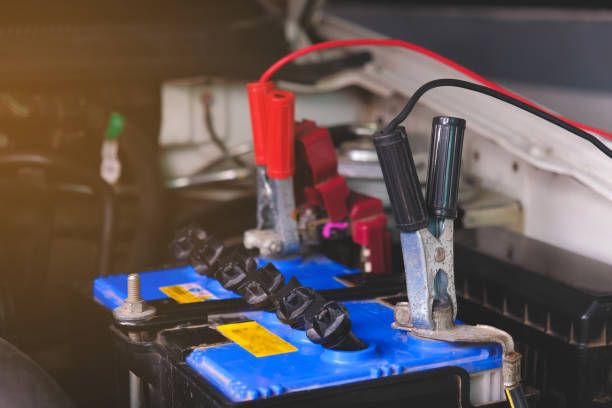 istock Charging battery car with electricity trough jumper cables,copy space. 1028059410