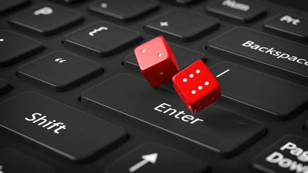 istock 3D rendering of  two red dices on black computer's keyboard 1028059930