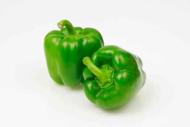 istock Two green bell peppers, on white background. 1028067376