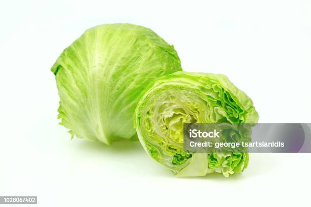 Iceberg Lettuce And One Cut Half On White Background Stock Photo - Download Image Now