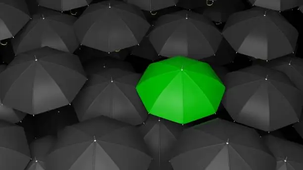 Photo of 3D rendering of classic large black umbrellas tops with one green standing out.
