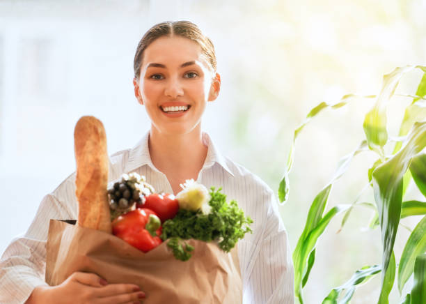istock woman holding grocery shopping bag 1028070340