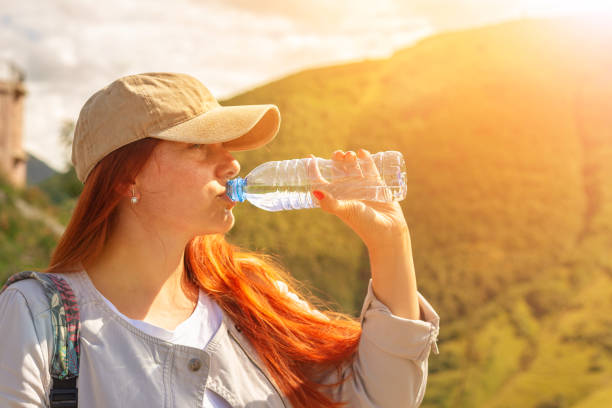istock Woman drinking water in summer sunlight 1028071754