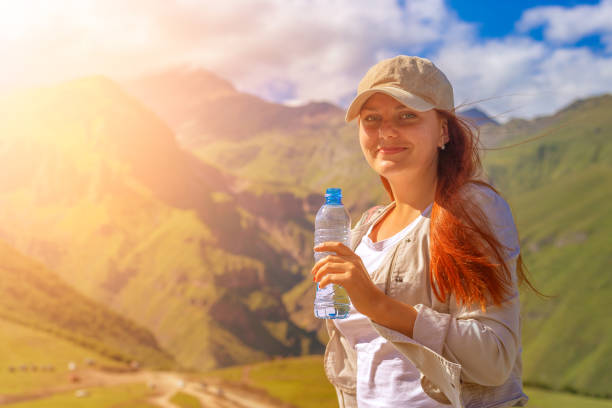 istock Woman drinking water in summer sunlight 1028071766