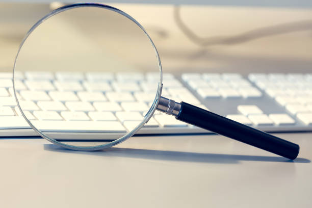istock Magnifier and computer keyboard as a symbol, searching, checking, monitoring virtual reality. 1028074290