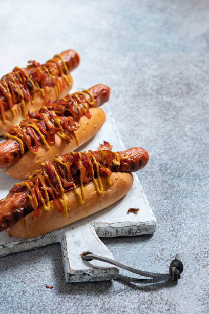 istock Hot Dog With Yellow Mustard, Onion, Bacon 1028074944