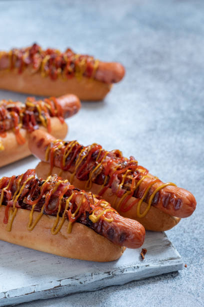 istock Hot Dog With Yellow Mustard, Onion, Bacon 1028075112