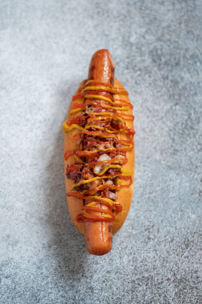 istock Hot Dog With Yellow Mustard, Onion, Bacon 1028075232