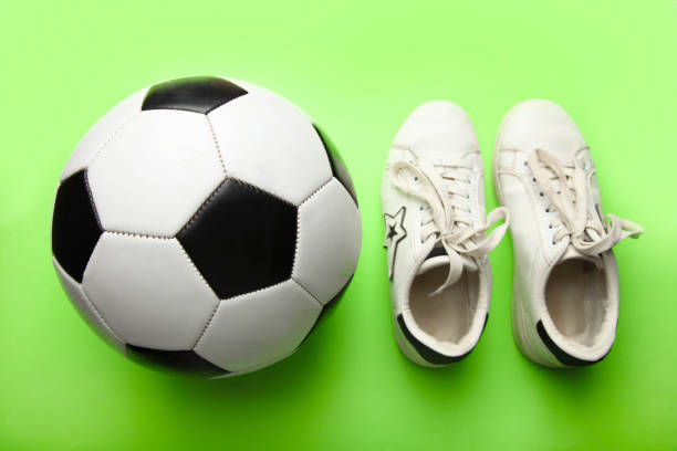 Creative collage picture of black white colors huge foot kick mini guy football instead head isolated on painted background.