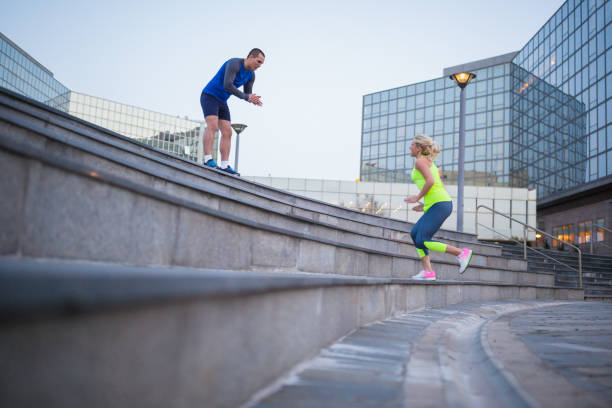istock Coach and young female athlete doing exercise outdoors 1028079184