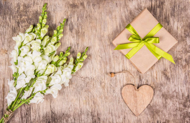istock Gift box, white flowers and heart. Romantic concept. Romantic background. Top view. 1028084988