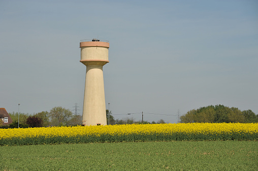 water tower in the countryside with rapeseed field in Beauce