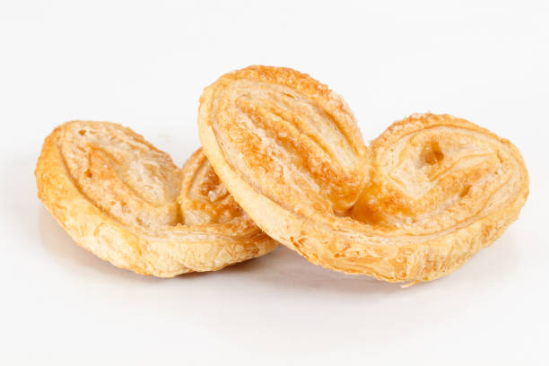 istock elephant ear, puff pastry cookie. Crispy heart or butterfly or bakery on white background for valentine 1028105290
