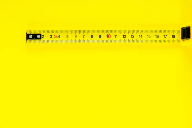 istock Yellow Measuring Tape on yellow background 1028105420