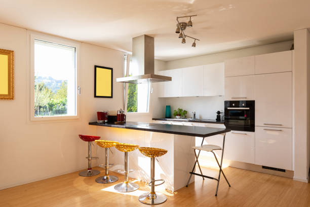 istock Kitchen in modern apartment with island and stools 1028107718