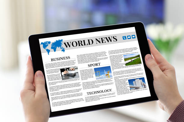 istock Female hands holding tablet with app world news on screen 1028112234