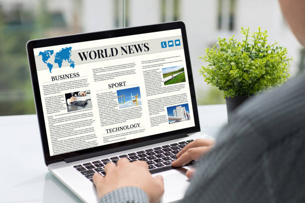 istock Man hands holding computer with app world news screen cafe 1028112258