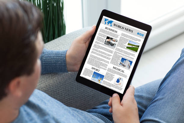 istock man in jeans holding tablet computer with app world news 1028112384