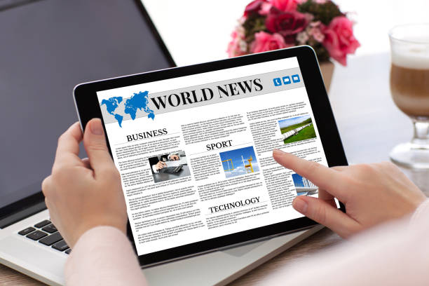 istock woman hands holding tablet computer  with app world news screen 1028112438