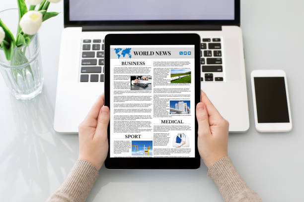istock woman hands holding tablet computer with app world news screen 1028112472