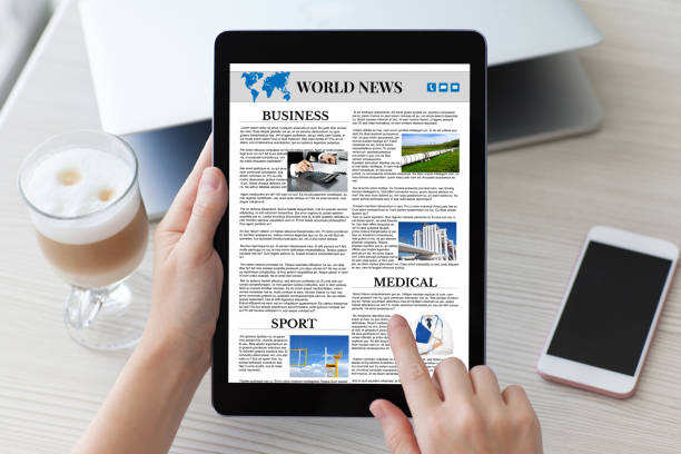 istock woman hands holding tablet computer with app world news screen 1028112532
