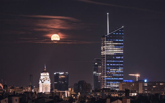 Bright moon over the business center in the city of Lyon, France.