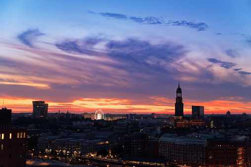View of Hamburg's landmarks at sunset - Dancing towers, Ferris Wheel and St. Michaelis church