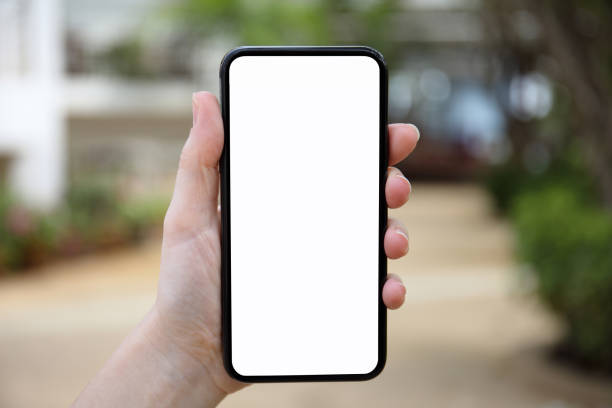 istock female hand holding phone with isolated screen on nature background 1028120138