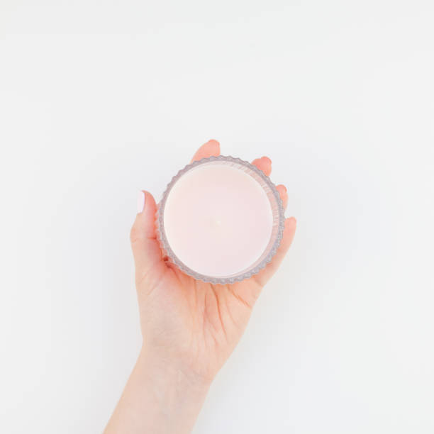 istock Woman hand with pink candle 1028122518