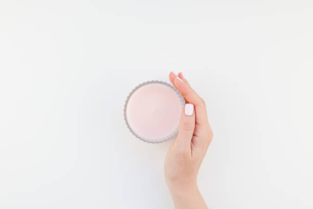 istock Woman hand with pink candle 1028122548