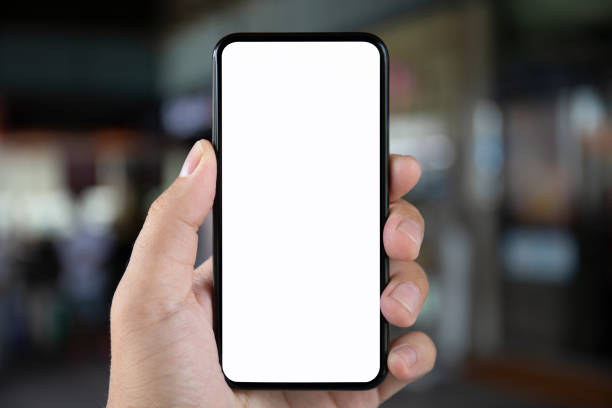 istock man hand holding phone with isolated screen on background city 1028122582