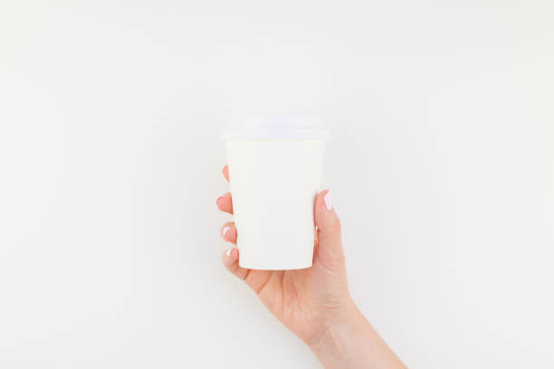 istock Mock up of coffee cup in female hand 1028122828