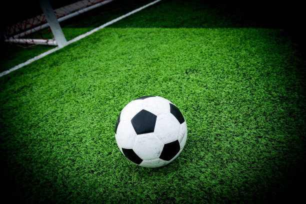 istock soccer field grass with ball at kick off point 1028122878