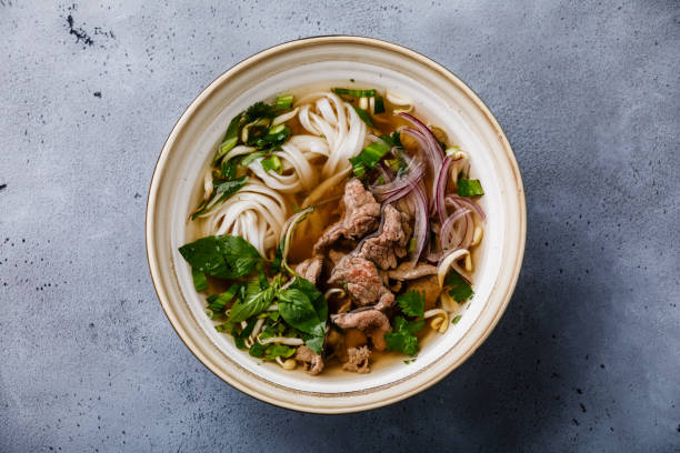Pho Bo vietnamese Soup with beef in bowl Pho Bo vietnamese Soup with beef in bowl on concrete background vietnam photos stock pictures, royalty-free photos & images