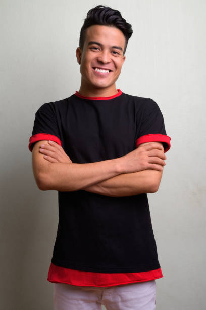 istock Young multi-ethnic man wearing black shirt against white background 1028123858
