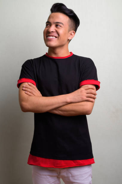 istock Young multi-ethnic man wearing black shirt against white background 1028123924