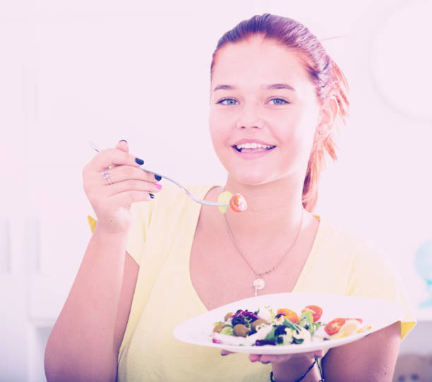 istock girl enjoying salad 1028123952