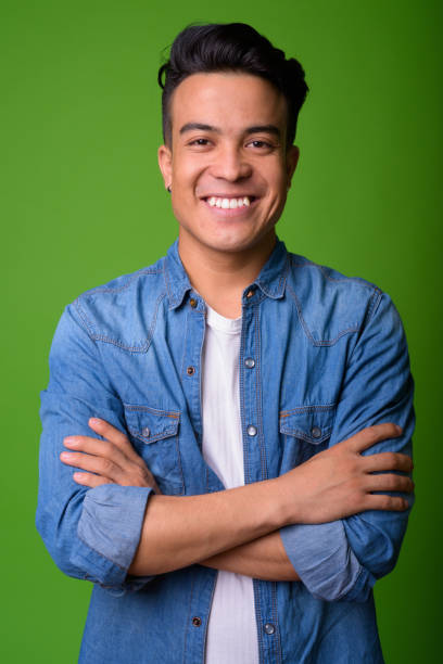 istock Young multi-ethnic man wearing smart clothing against green background 1028127232