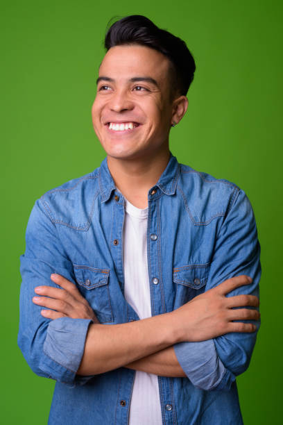 istock Young multi-ethnic man wearing smart clothing against green background 1028127428