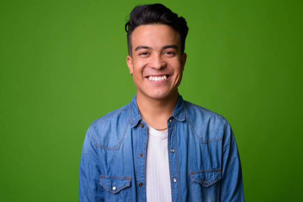 istock Young multi-ethnic man wearing smart clothing against green background 1028127506