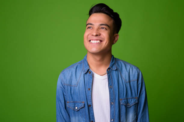 istock Young multi-ethnic man wearing smart clothing against green background 1028127594