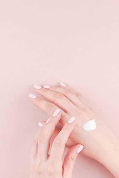 istock Woman moisturizing her hand with cosmetic cream 1028134838