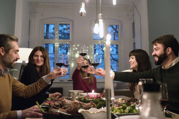 istock friends clinking wine glasses at christmas dining table 1028135414
