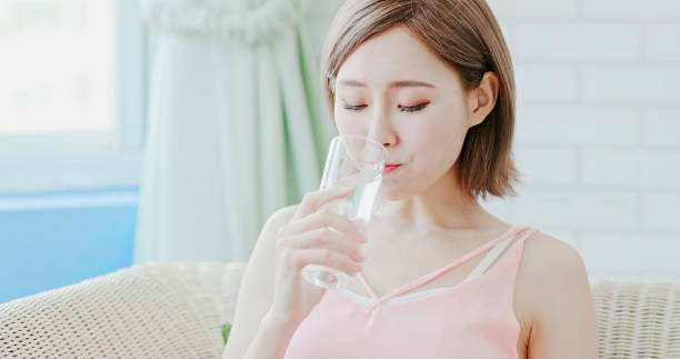 istock woman drink water 1028136574