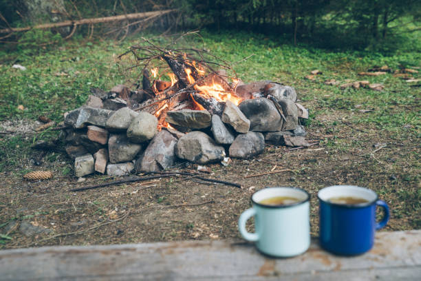 istock two metal cups with tea. fire on background 1028139958