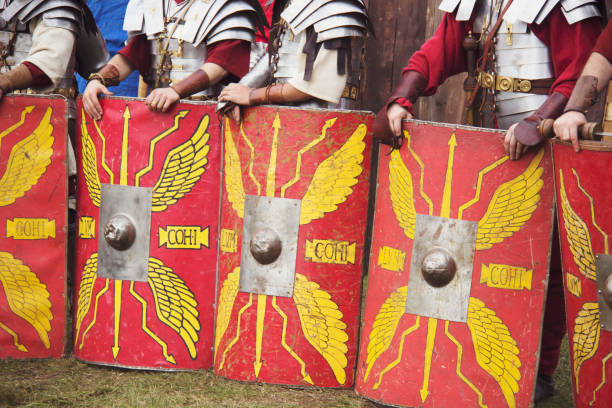 the line of roman legionaries is preparing for fight. - history knight historical reenactment military imagens e fotografias de stock
