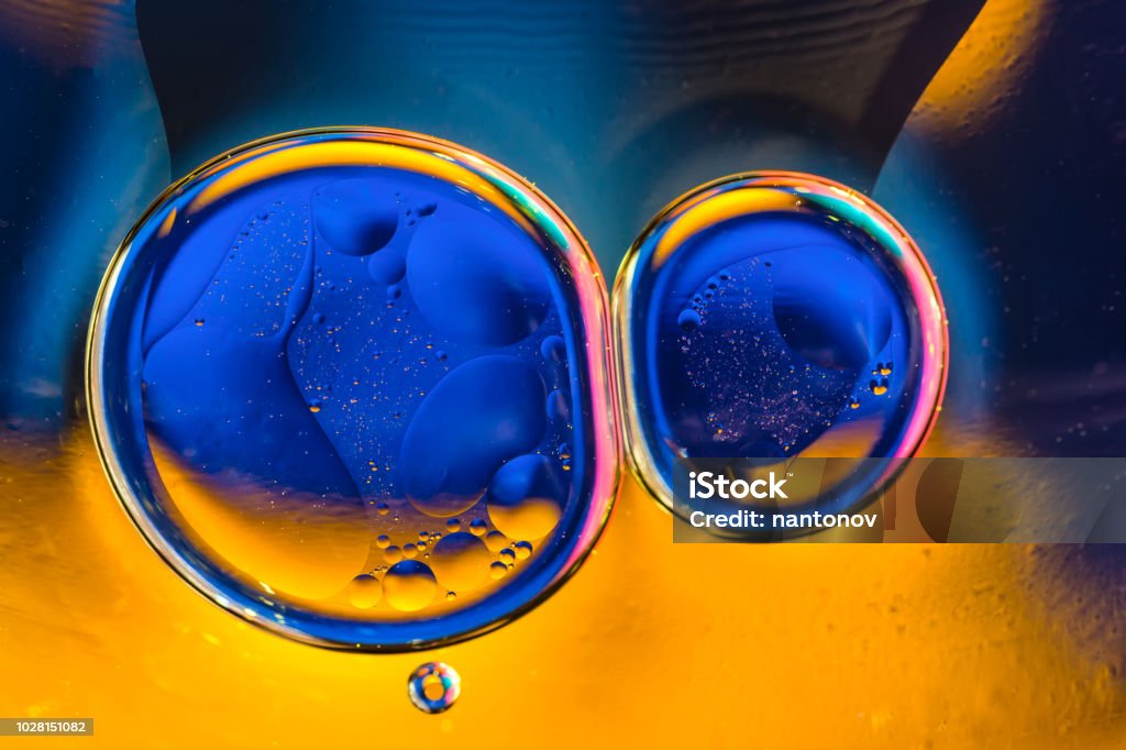 Beautiful color abstract background from mixied water and oil. Blue and orange water ripples and bubbles reflections. Beautiful color abstract background from mixied water and oil. Blue and orange water ripples and bubbles reflections Abstract Stock Photo
