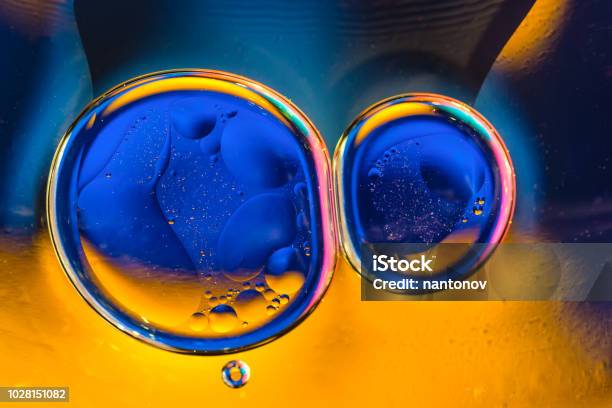 Beautiful Color Abstract Background From Mixied Water And Oil Blue And Orange Water Ripples And Bubbles Reflections Stock Photo - Download Image Now