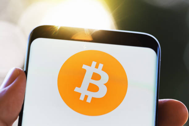 istock Smart phone with bitcoin logo held in someone's hand 1028154752